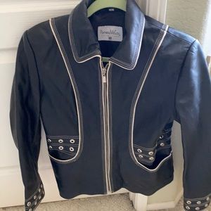 Leather jacket with grommet details